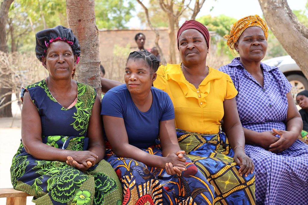 4 Zimbabwean women sat on bench
