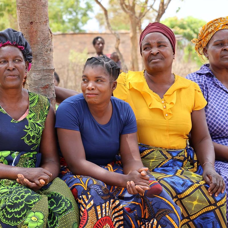 4 Zimbabwean women sat on bench