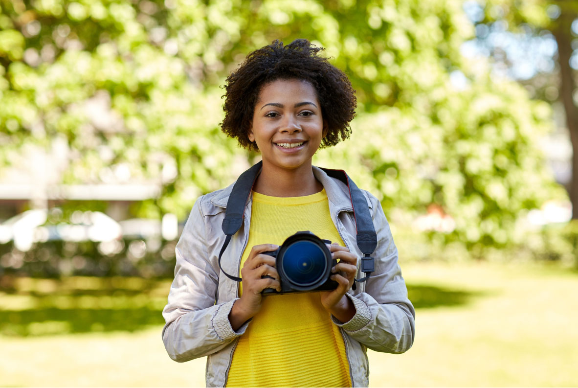 Woman smiling while holding camera